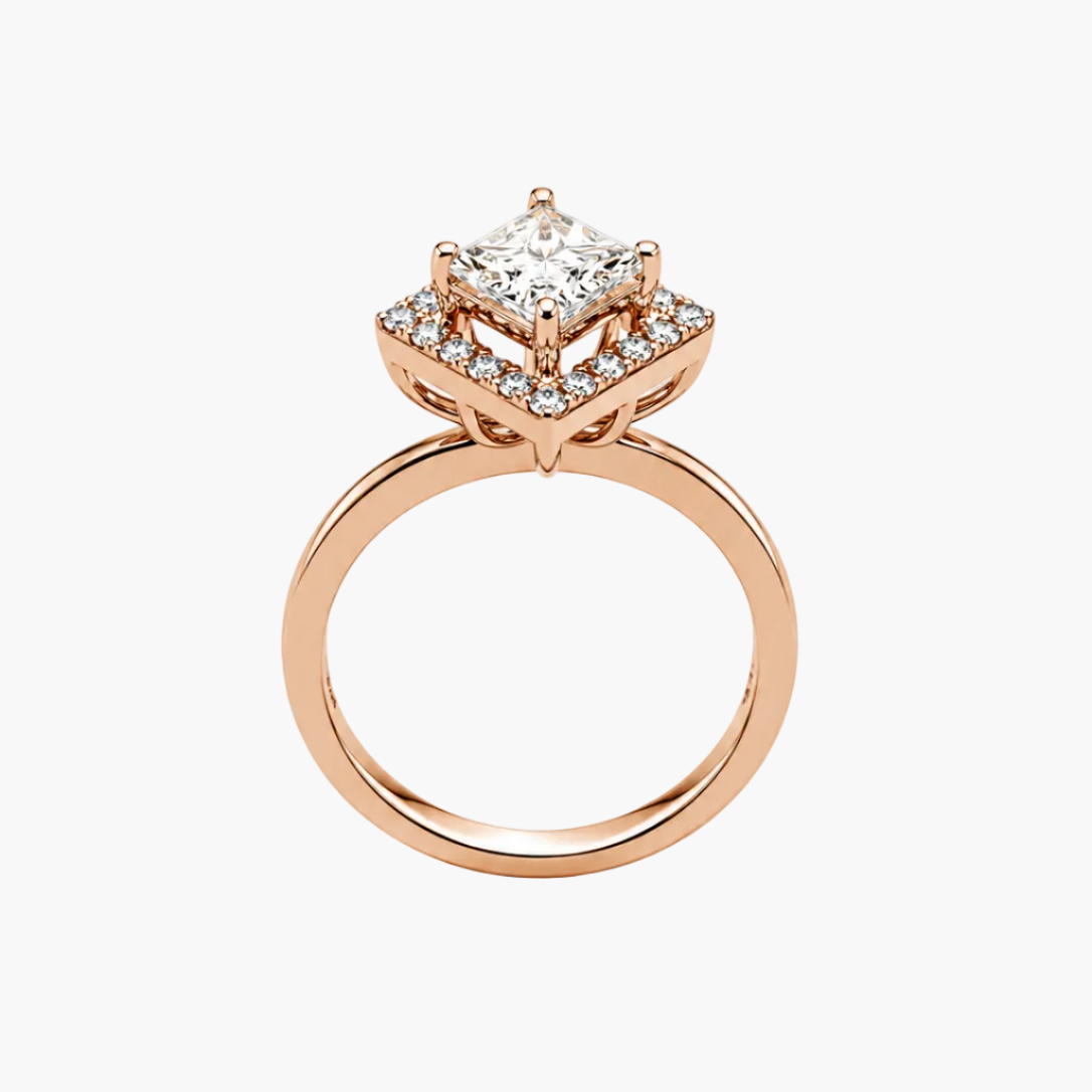 A rose gold engagement ring featuring a princess-cut diamond center stone surrounded by a halo of smaller diamonds, set on a polished band, shown against a plain white background.