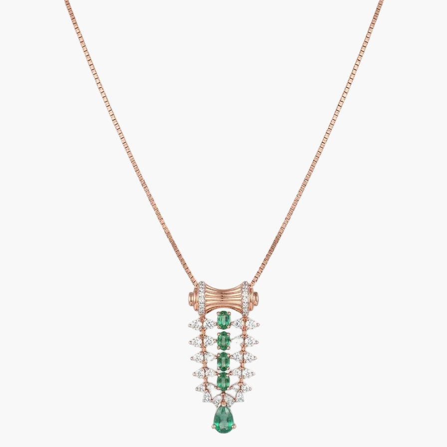 A rose gold necklace with a detailed pendant featuring green emerald-cut stones and clear pavé-set stones, shown on a plain white background.