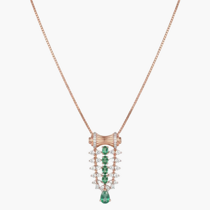 A rose gold necklace with a detailed pendant featuring green emerald-cut stones and clear pavé-set stones, shown on a plain white background.