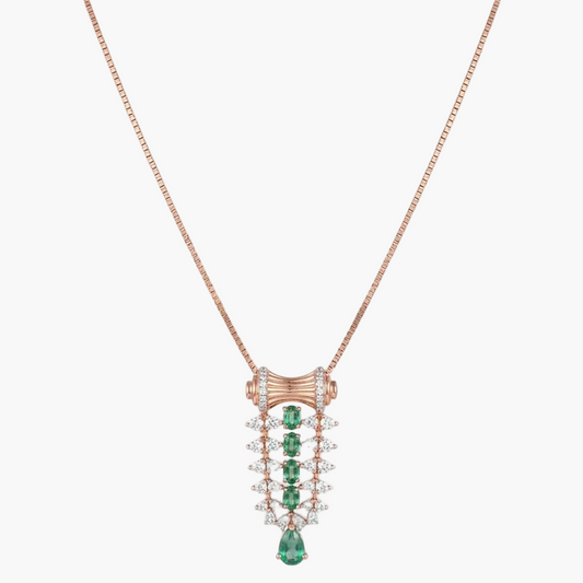A rose gold necklace with a detailed pendant featuring green emerald-cut stones and clear pavé-set stones, shown on a plain white background.