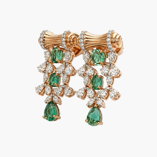 A pair of luxury rose gold drop earrings featuring emerald-cut green gemstones and clear pavé-set diamonds, displayed on a clean white background.