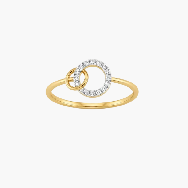 A gold ring featuring two interlocking circular designs, with one ring encrusted with small clear stones, set against a plain white background.