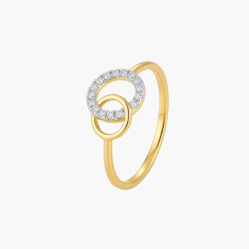 A gold ring featuring two interlocking circular designs, with one ring encrusted with small clear stones, set against a plain white background.