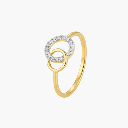 A gold ring featuring two interlocking circular designs, with one ring encrusted with small clear stones, set against a plain white background.