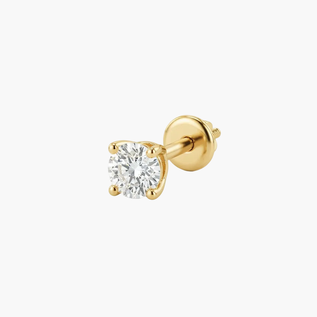 A single yellow gold stud earring featuring a round brilliant-cut clear gemstone in a four-prong setting, shown on a clean white background.