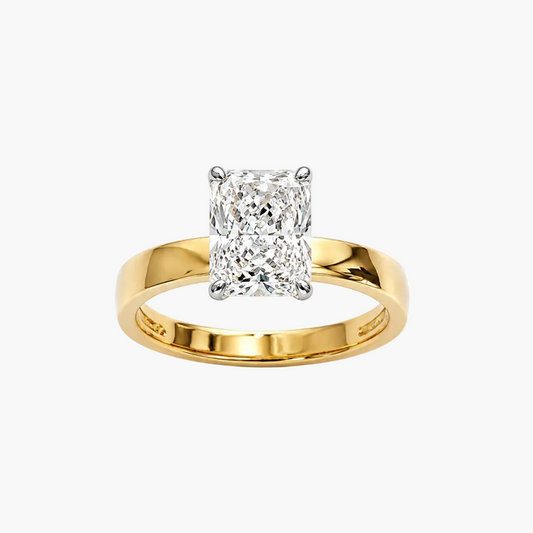 A yellow gold solitaire engagement ring featuring a rectangular radiant-cut diamond in a four-prong setting, shown on a clean white background.