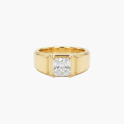 A yellow gold ring featuring a large, square-cut clear gemstone in a four-prong setting, presented on a clean white background.