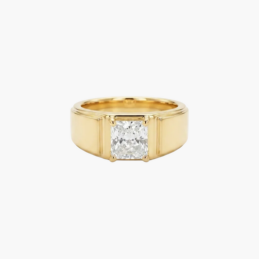 A yellow gold ring featuring a large, square-cut clear gemstone in a four-prong setting, presented on a clean white background.