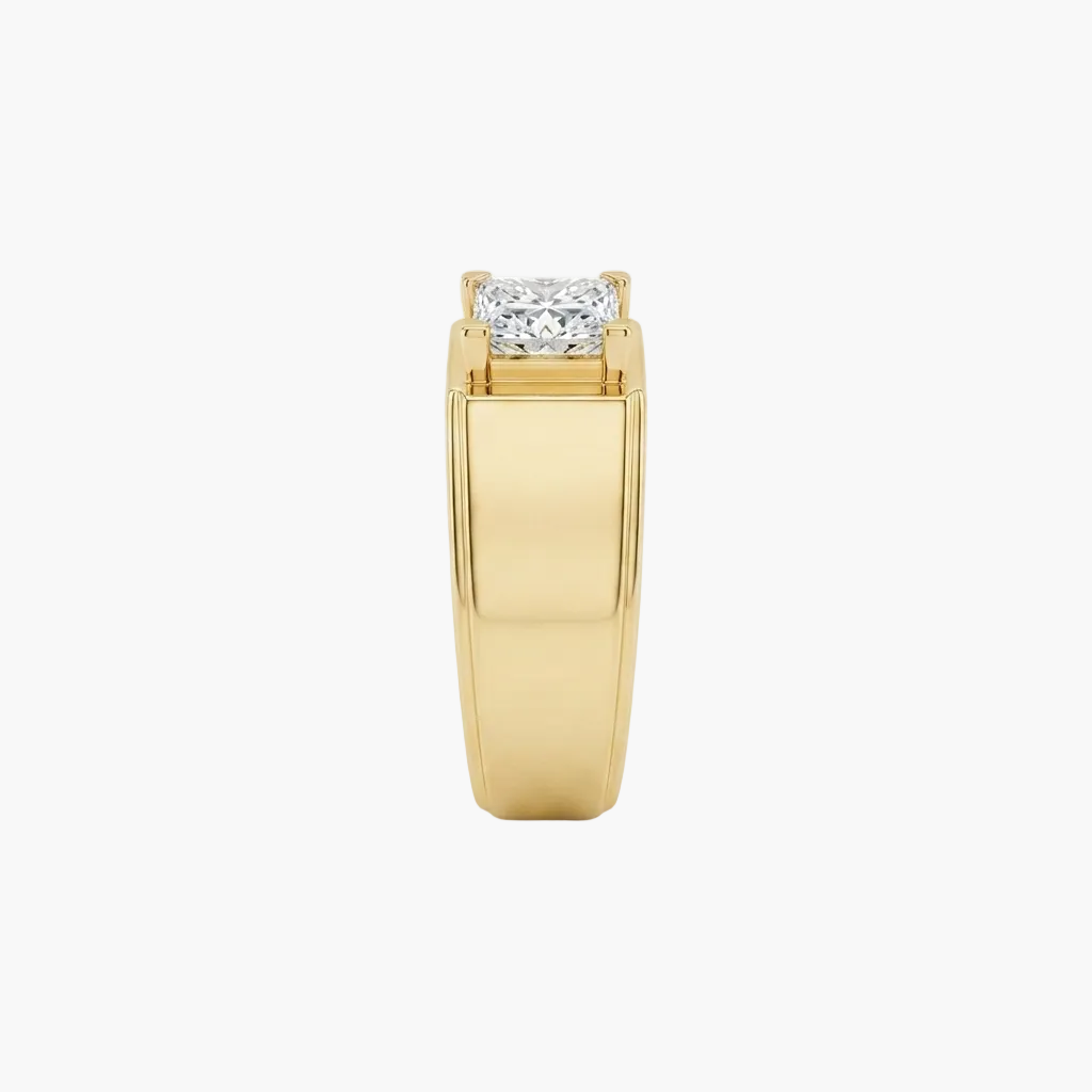 A yellow gold ring with a rectangular prong setting holding a round brilliant-cut diamond, shown against a plain white background.