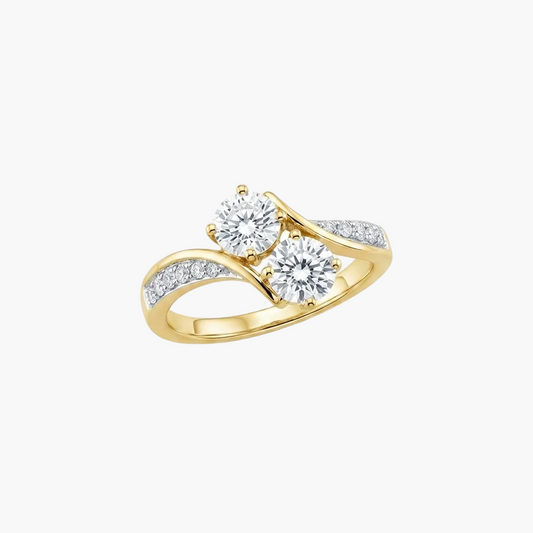 A yellow gold split-shank ring featuring two round brilliant-cut clear center stones and a row of small pavé-set clear stones along the band, shown on a plain white background.