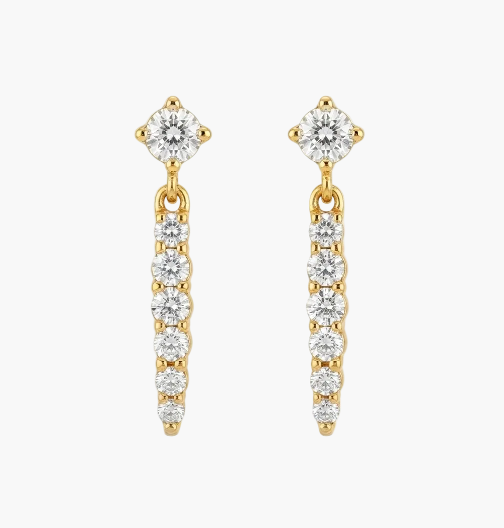 A pair of gold dangle earrings with clear gemstones, shown on a plain white background.