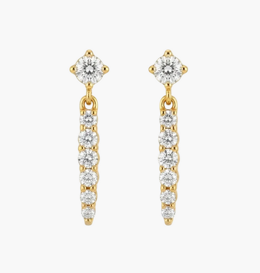 A pair of gold dangle earrings with clear gemstones, shown on a plain white background.