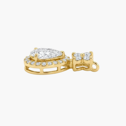A yellow gold pendant featuring a pear-cut diamond center stone surrounded by a halo of small round diamonds, shown on a clean white background.