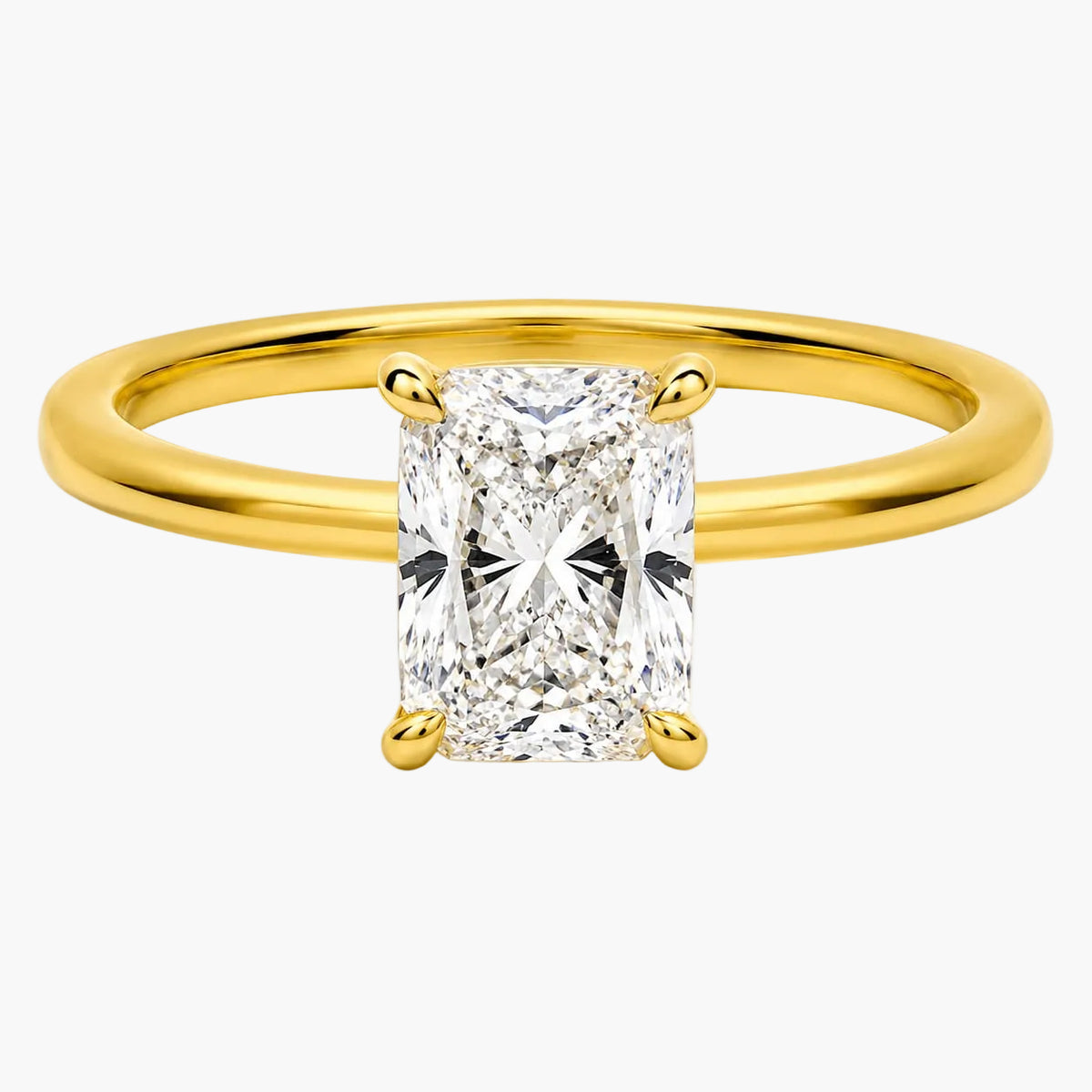 A yellow gold solitaire ring featuring a large rectangular radiant-cut diamond center stone in a four-prong setting, shown on a clean white background.