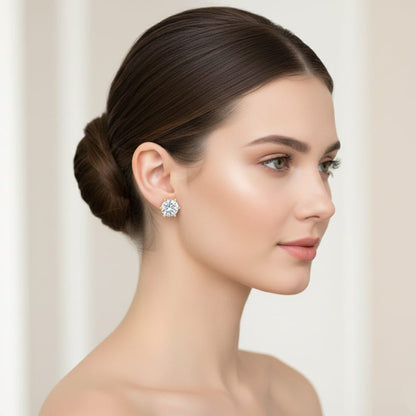 Woman wearing a diamond earring with a plain background