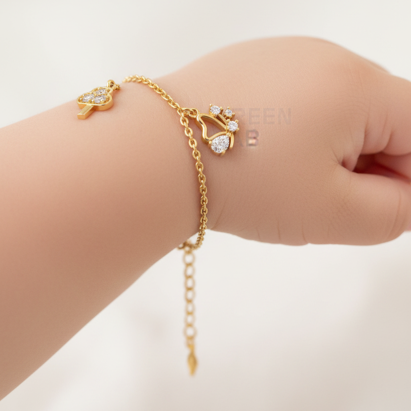 Baby wearing delicate yellow gold diamond charm bracelet with arrow-cloud, butterfly and star diamond charms