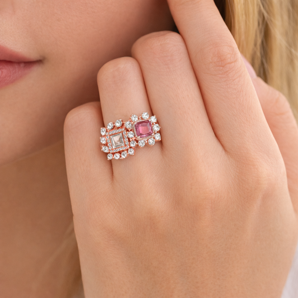 Close-up of a hand wearing a ring with a pink gemstone and diamond accents.
