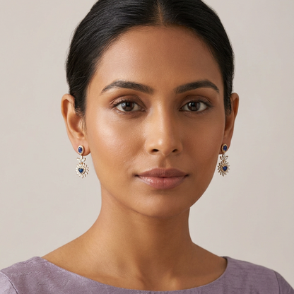 Female model wearing both blue heart earrings at a very petite scale