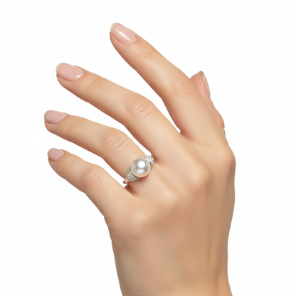 Female model wearing delicate pearl and diamond ring