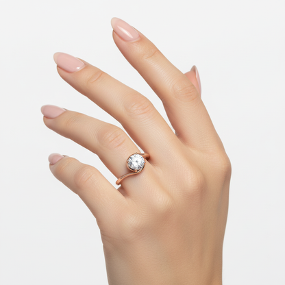 Female model wearing delicate rose gold solitaire diamond ring