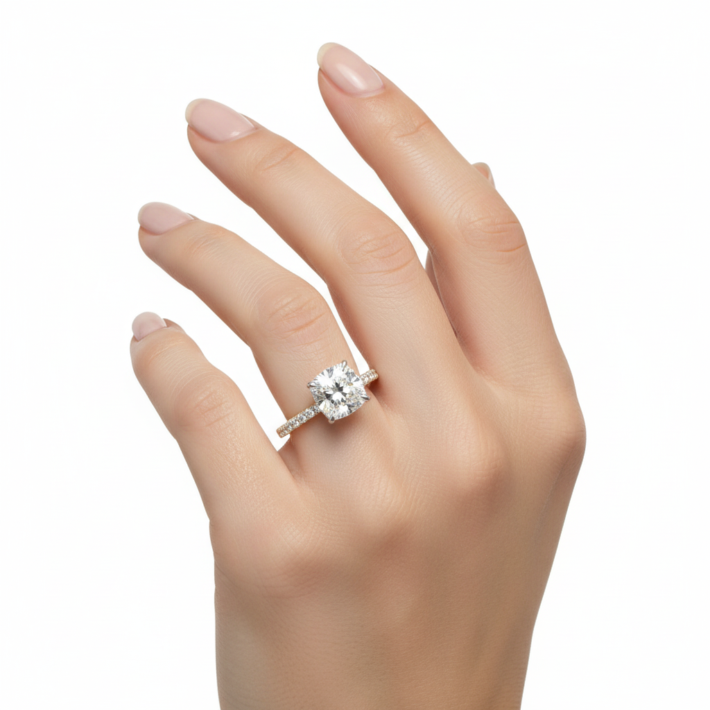 Female model wearing delicate two-tone gold cushion-cut diamond ring