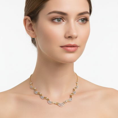 Female model wearing delicate two-tone gold diamond wave necklace