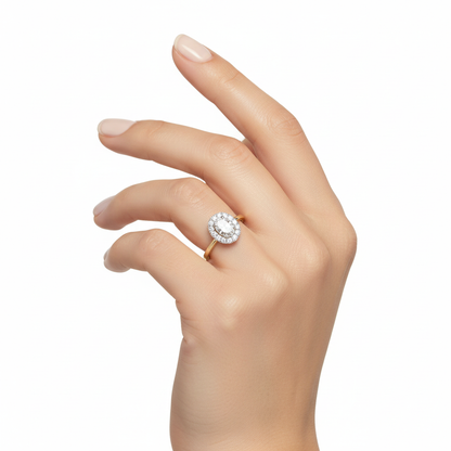 Female model wearing delicate two-tone gold oval diamond halo ring