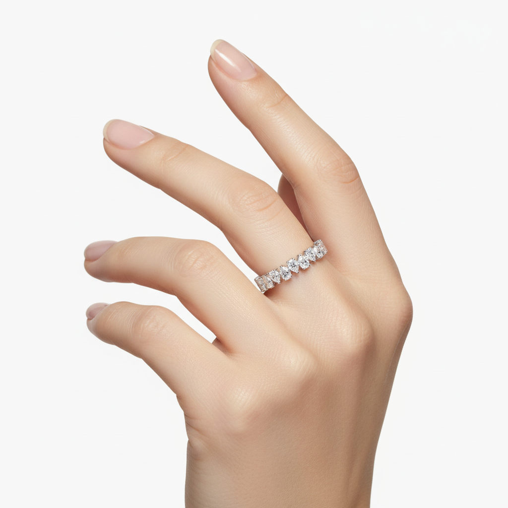 Female model wearing delicate white gold diamond eternity band