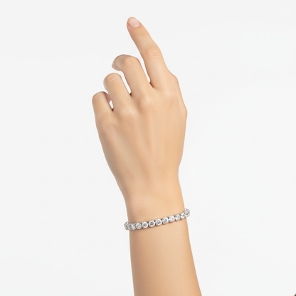 Female model wearing delicate white gold diamond tennis bracelet