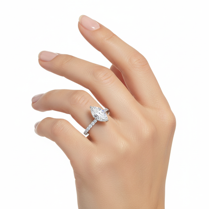 Female model wearing delicate white gold marquise diamond ring