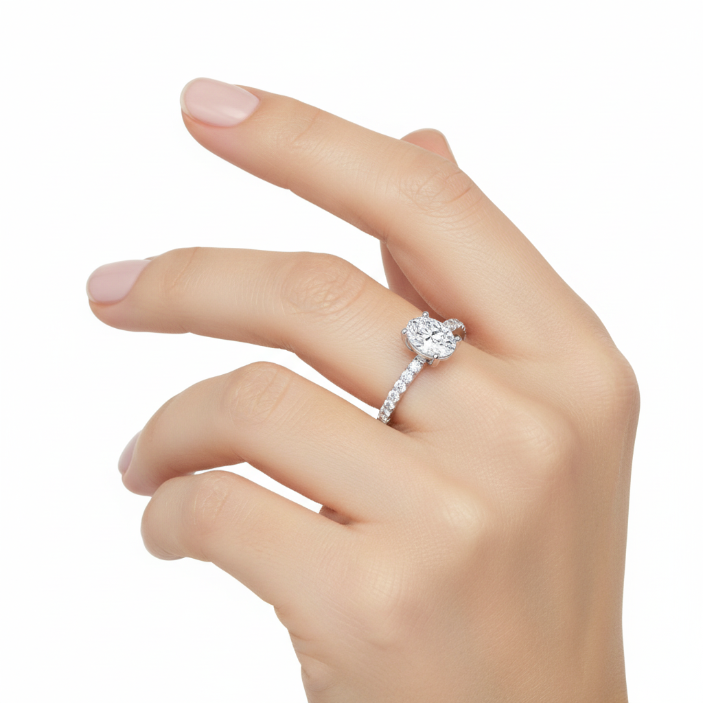 Female model wearing delicate white gold oval diamond ring