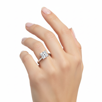 Female model wearing delicate white gold princess-cut diamond solitaire ring