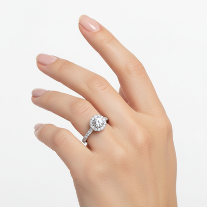 Female model wearing delicate white gold round diamond halo ring