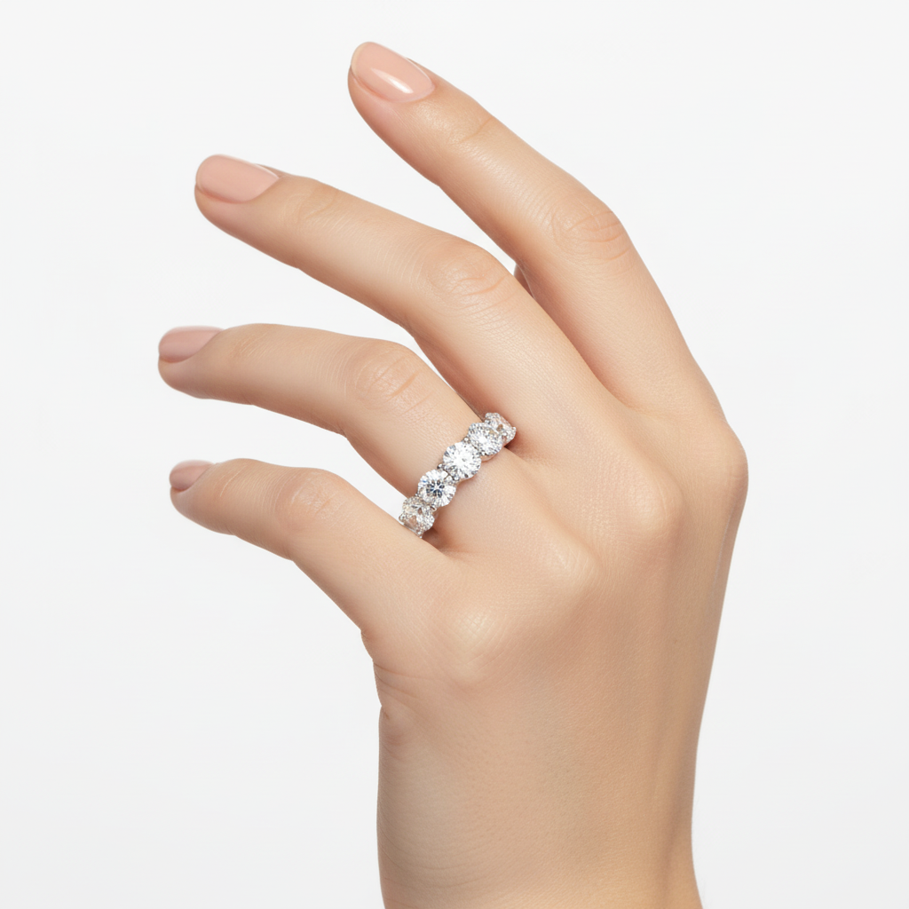 Female model wearing delicate white gold seven-stone diamond band