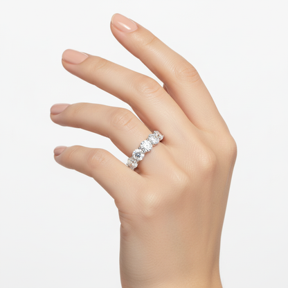 Female model wearing delicate white gold seven-stone diamond band