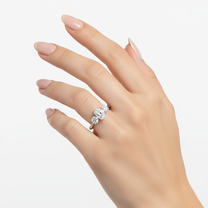 Female model wearing delicate white gold three-stone diamond ring