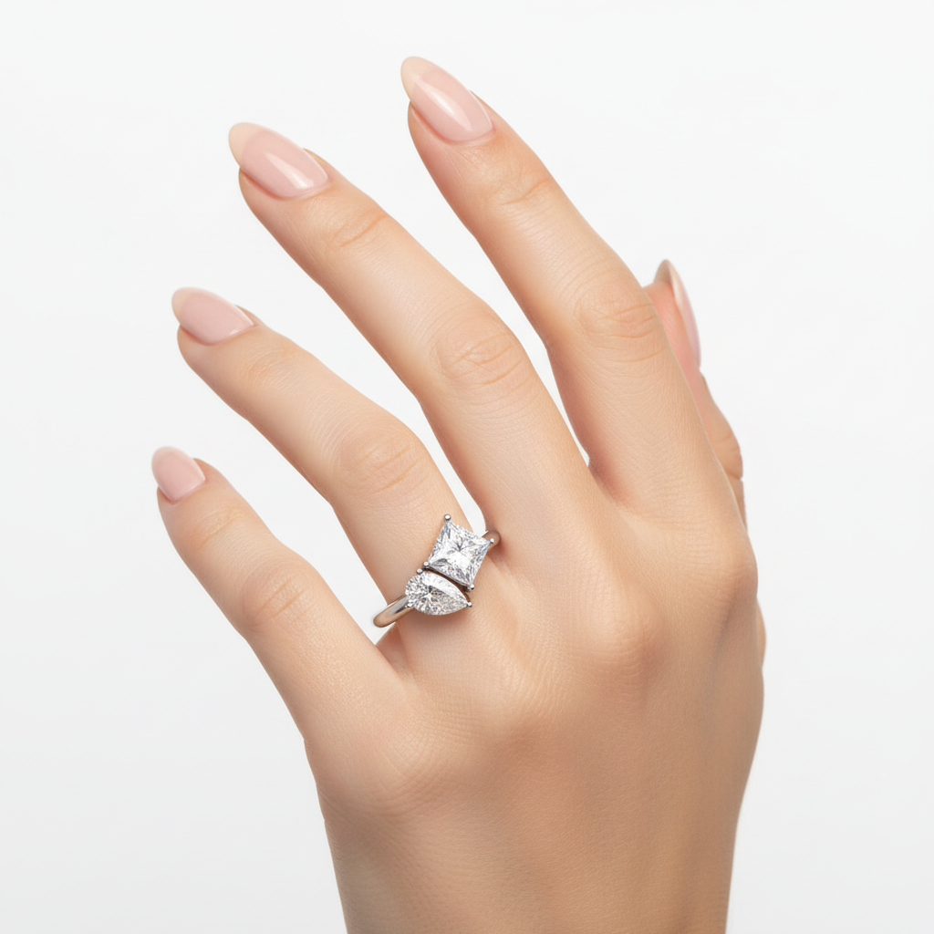 Female model wearing delicate white gold three-stone diamond ring