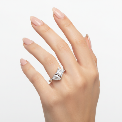 Female model wearing delicate white gold three-stone diamond ring
