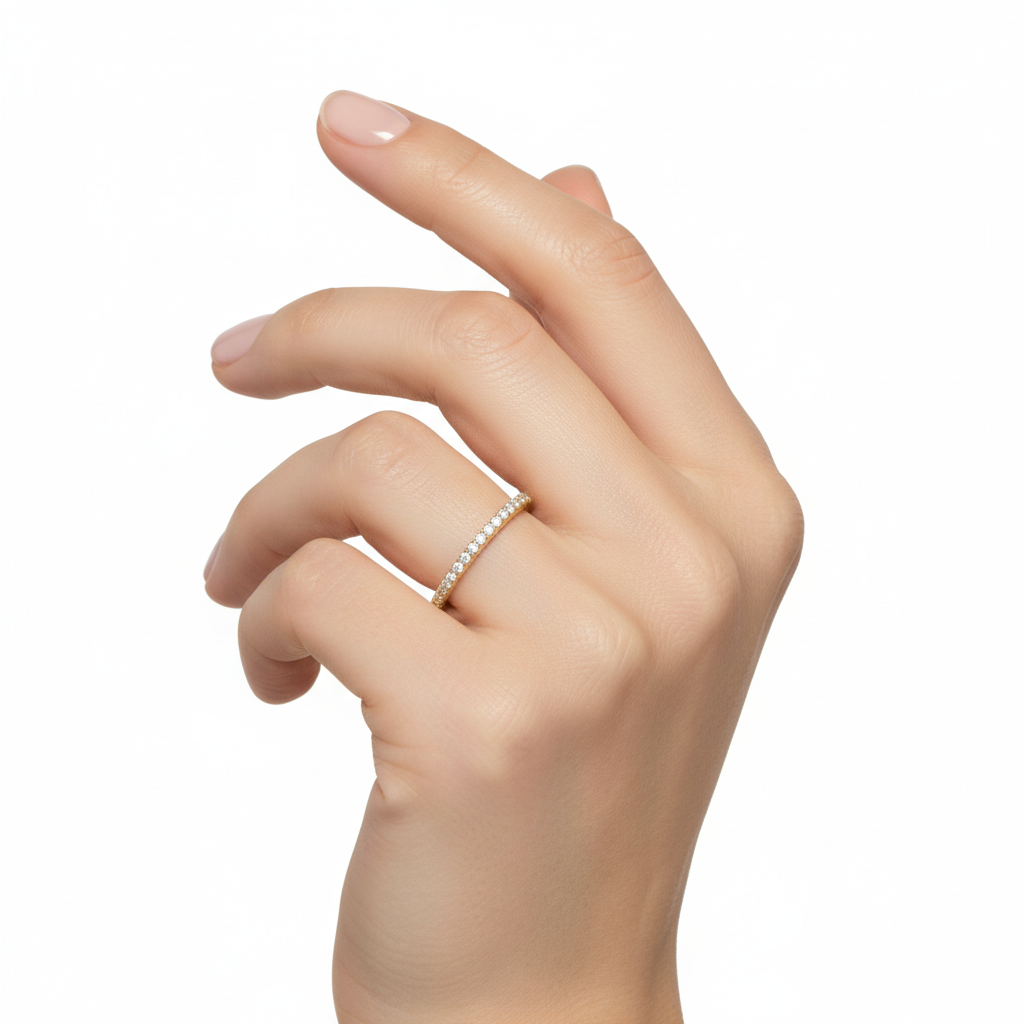 Female model wearing delicate yellow gold diamond wedding band
