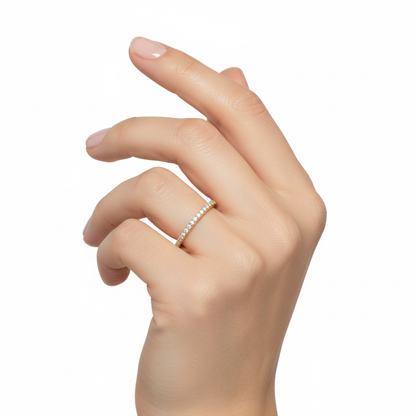 Female model wearing delicate yellow gold diamond wedding band