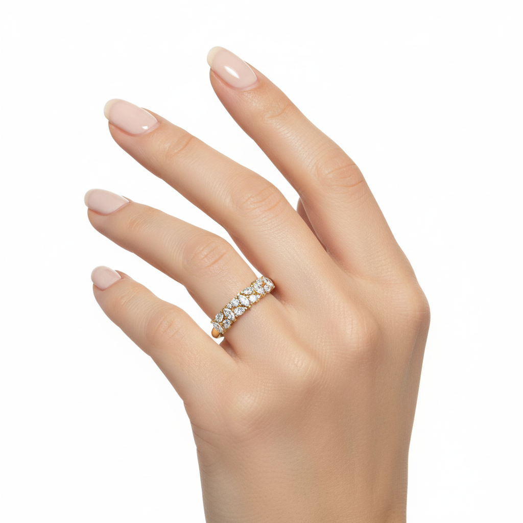 Female model wearing delicate yellow gold mixed-cut diamond band