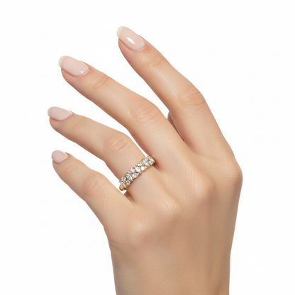 Female model wearing delicate yellow gold mixed-cut diamond band