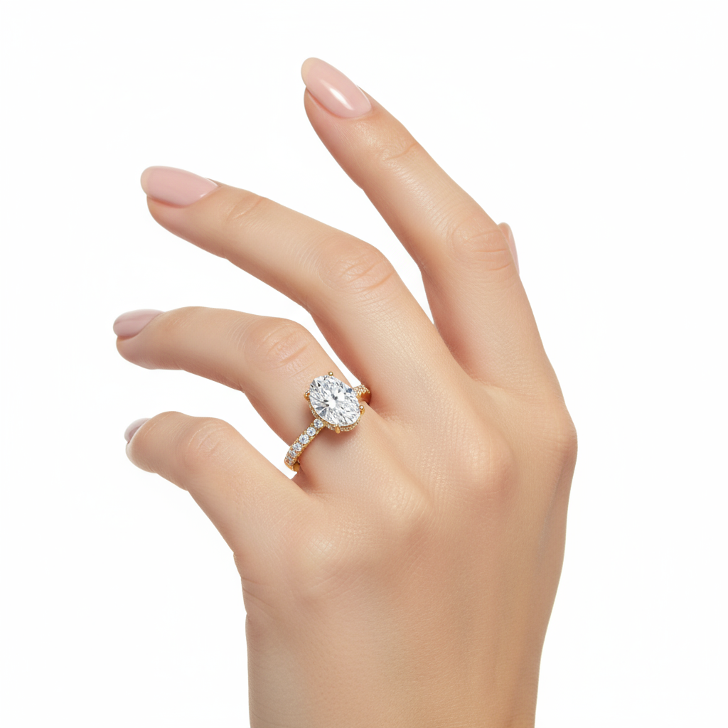 Female model wearing delicate yellow gold oval diamond ring with hidden halo