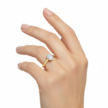 Female model wearing delicate yellow gold oval diamond solitaire ring