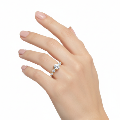 Female model wearing delicate yellow gold seven-stone diamond ring