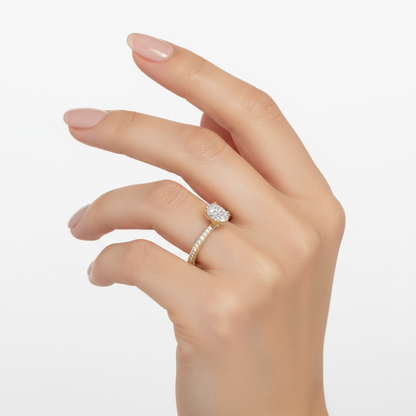 Female model wearing delicate yellow gold solitaire diamond ring