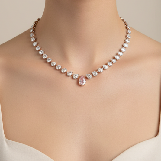 Female model wearing diamond necklace with pink centerpiece