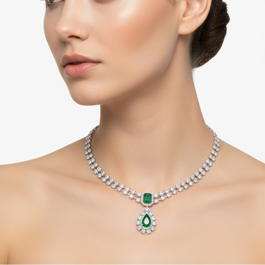 Female model wearing emerald and diamond Art Deco necklace
