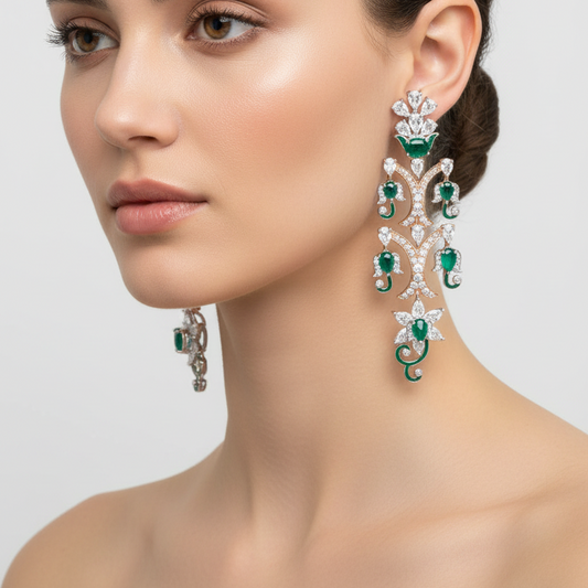 Female model wearing emerald and diamond botanical chandelier earrings