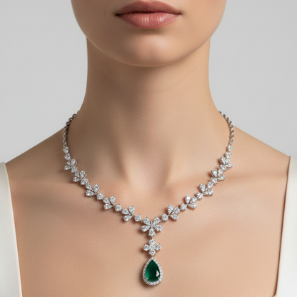 Female model wearing emerald and diamond butterfly necklace